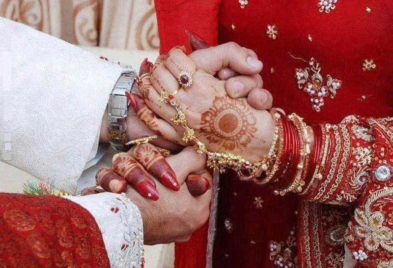 A bride and groom holding hands during a wedding ceremony